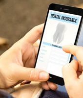 a person scrolling through a dental insurance phone app