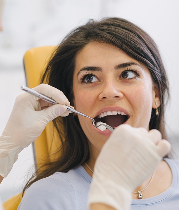 woman looking up at dentist after tooth extraction