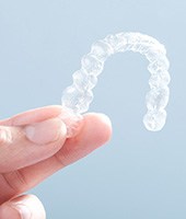 Patient holding clear aligner