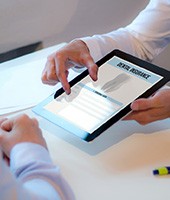 Patient reviewing dental insurance forms on tablet