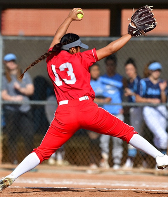 A girl playing softball and protecting her mouth from injury