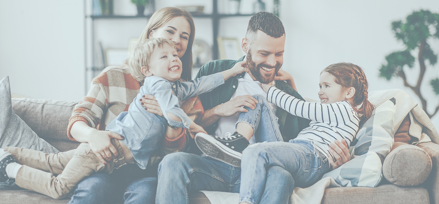 youtube thumbnail family of four laughing and smiling on couch