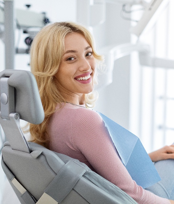 Patient smiling while sitting in treatment chair