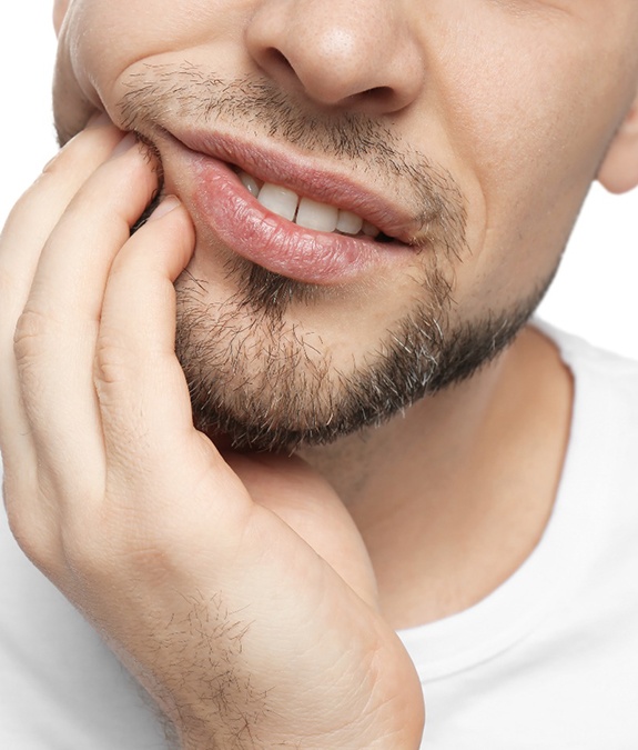 Man with hand against his jaw 