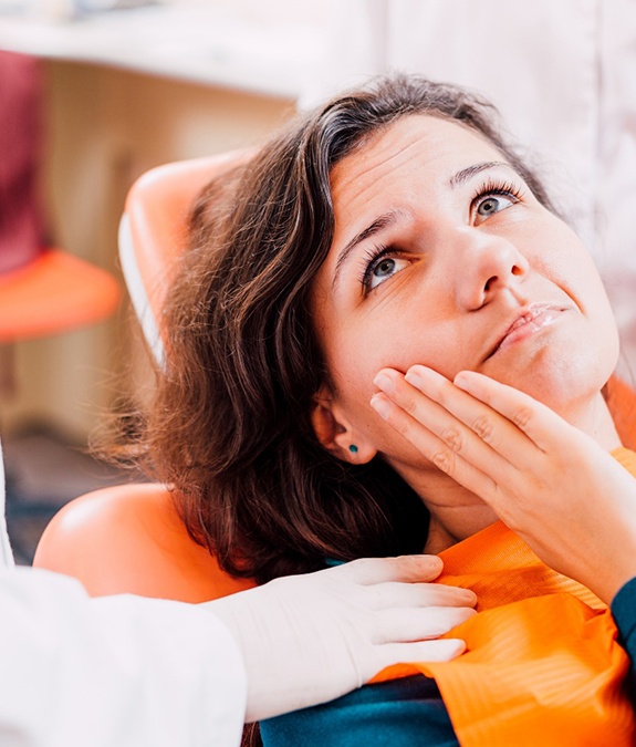 Woman with toothache listening to an emergency dentist in Mansfield