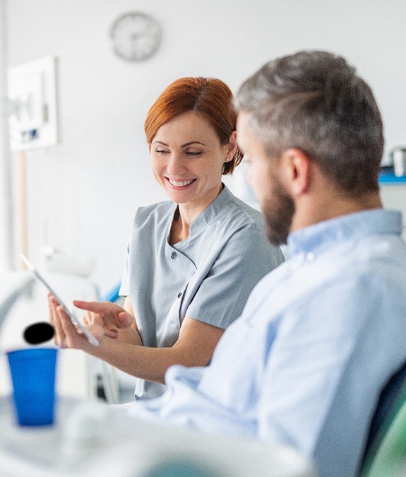 Mansfield dentist answering patient's questions about tooth extractions