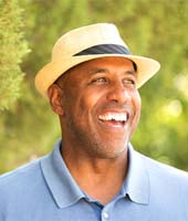 man in a blue polo shirt standing in nature