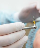 Dentist preparing to place dental implant during surgery 