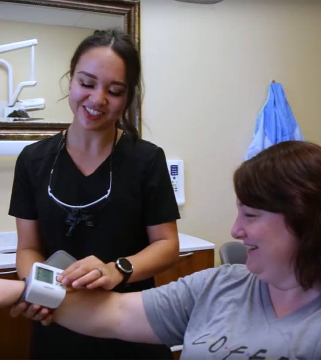 three dentists smiling at camera