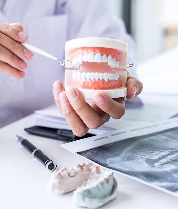 Dentist showing dental patient a smile model during treatment planning