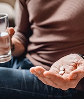 person holding pills in hand 