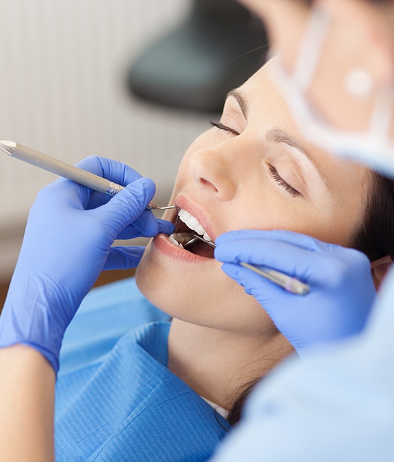 woman sedated while having teeth cleaned