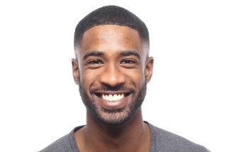 man with perfect white smile after replacing missing teeth