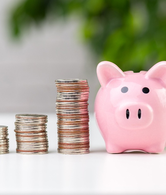 Coins next to a piggy bank