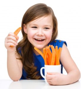 young girl eating carrots 
