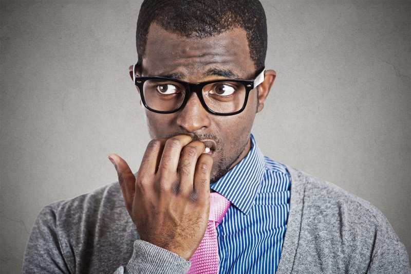 A man with a dental anxiety thinking about the dentist