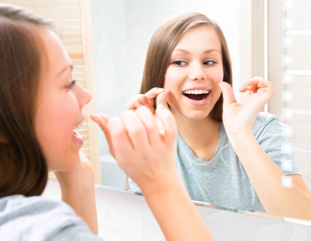 Woman flossing her teeth