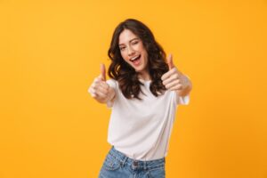 Woman smiling and giving thumbs up