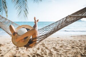 Woman in hammock on the beach.